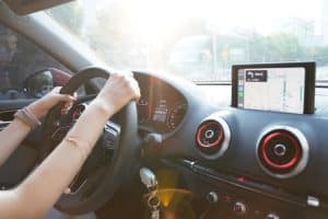 Woman driver on her car with latest management technology.
