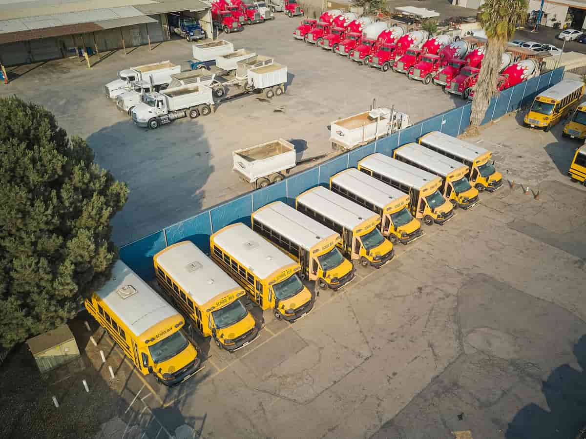 Commercial fleet vehicles parked at a fleet operations yard.