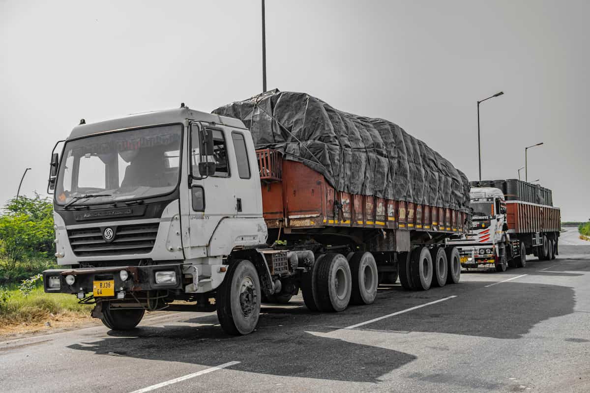 Commercial fleet trucks operating on the road.