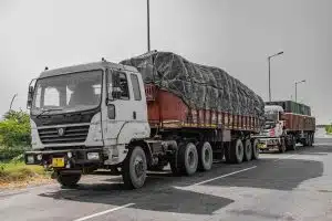 loaded cargo trucks on road Heavy-duty commercial freight trucks parked on the side of a highway, illustrating fleet risk management and liability issues for large vehicle operations.